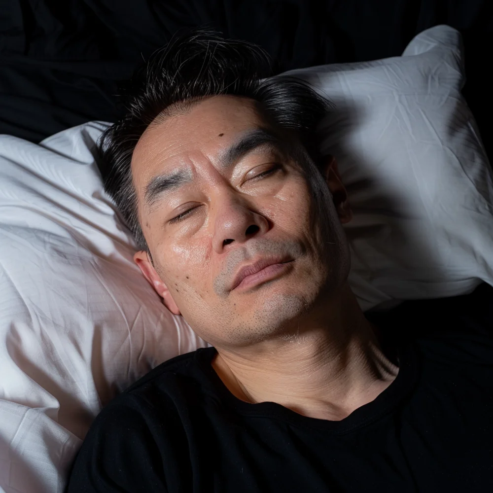 Aged asian man experiencing sleep disturbances due to andropause.