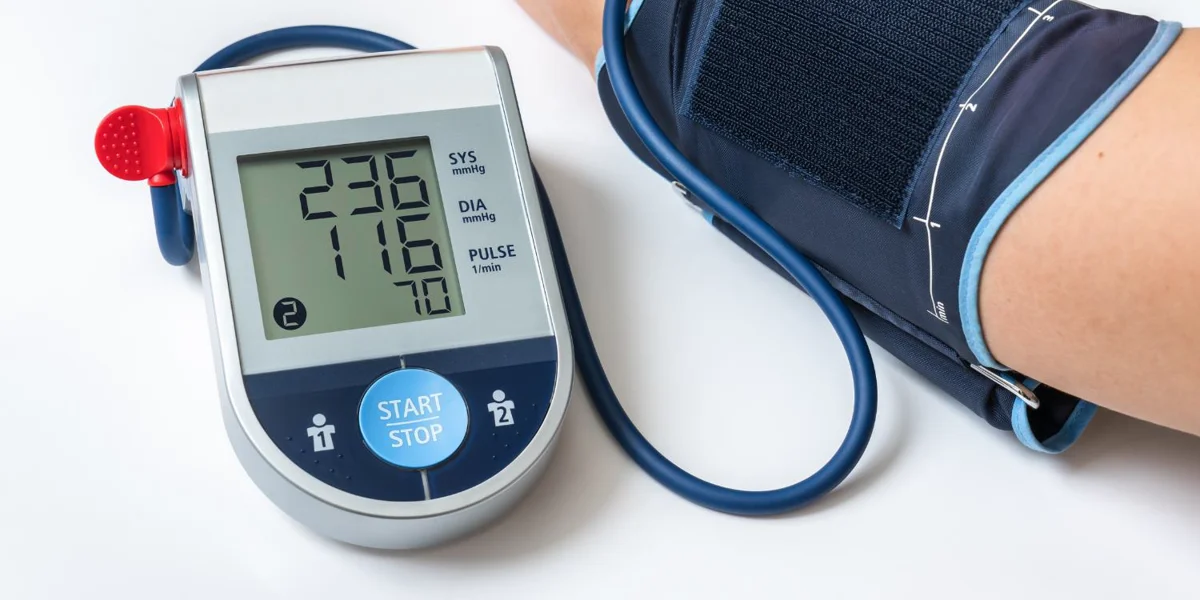 Blood pressure monitor showing high blood pressure reading emphasizing the importance of managing blood pressure to reduce alzheimer's risk.