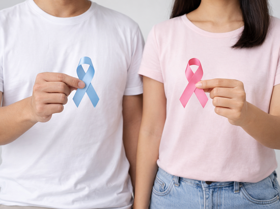 Man and woman holding blue and pink cancer awareness ribbons.