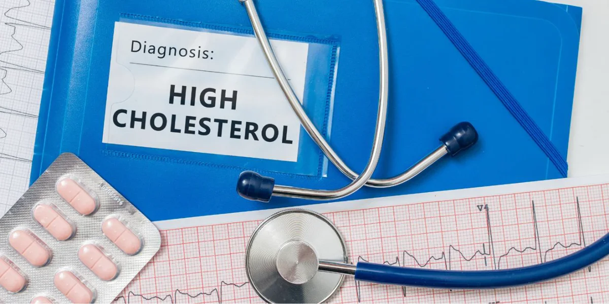 Stethoscope, medication, and diagnosis file indicating high cholesterol, highlighting the importance of managing cholesterol levels to reduce Alzheimer's risk.