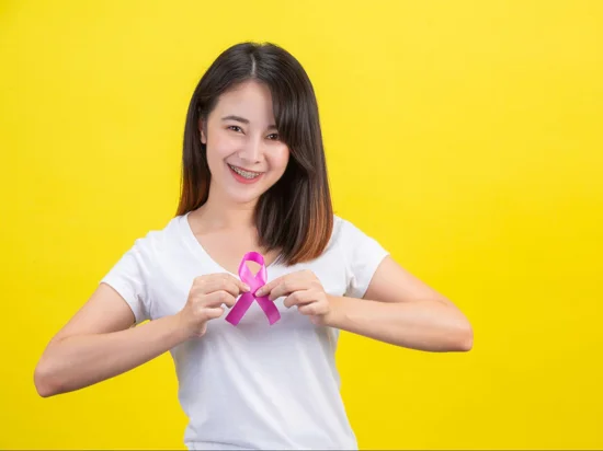 Young asian woman showing support for breast cancer prevention through regular mammogram screenings.