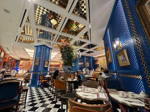 Luxurious Moroccan-inspired interior of Bacha Coffee at ION Orchard, with blue walls and checkered flooring.