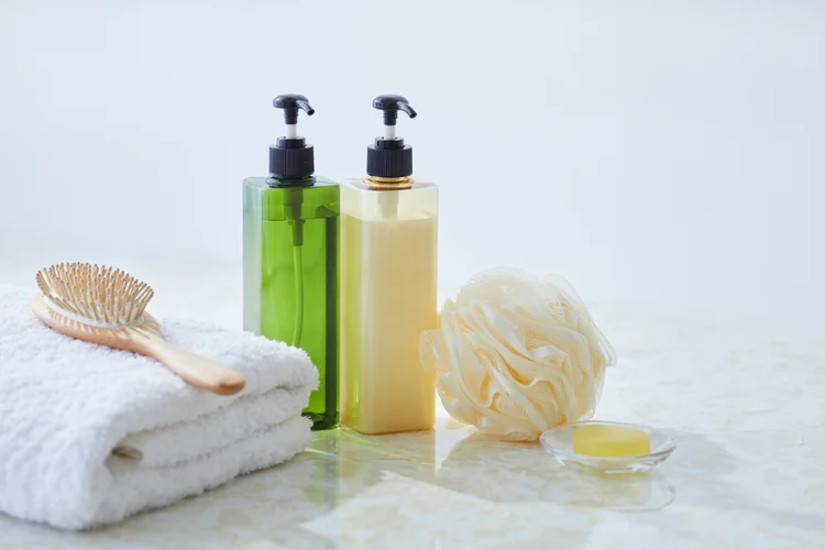 Bathroom essentials with bodywash and loofah to represent hygiene related to candidiasis care.