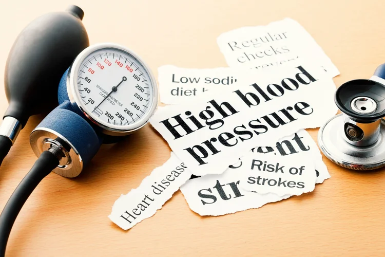 Blood pressure monitor and articles showing heart attack, stroke, and leukaemia risk factors.