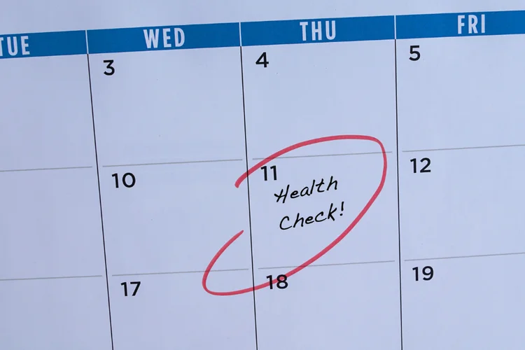Health screening appointment marked on calendar as reminder for regular checks for men over 40.