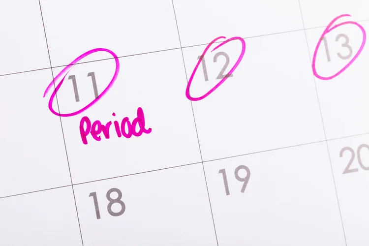 Calendar marked with period dates to indicate considerations for women’s premarital screening.