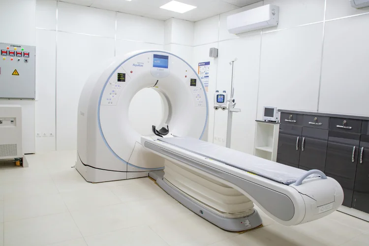CT scan machine in hospital imaging room used to diagnose injuries and conditions.