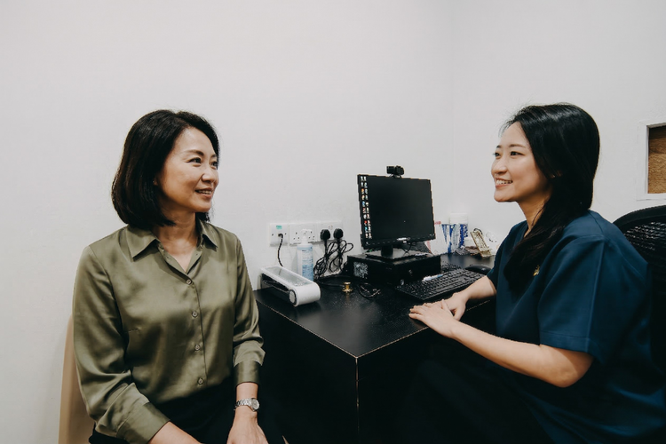 Woman consulting doctor on menopause symptoms and HRT treatment options.