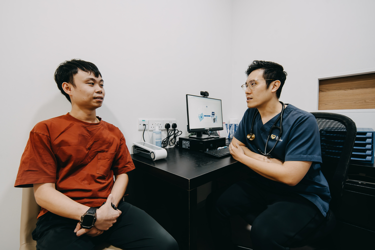 Male doctor discussing premature ejaculation treatment options with a patient.