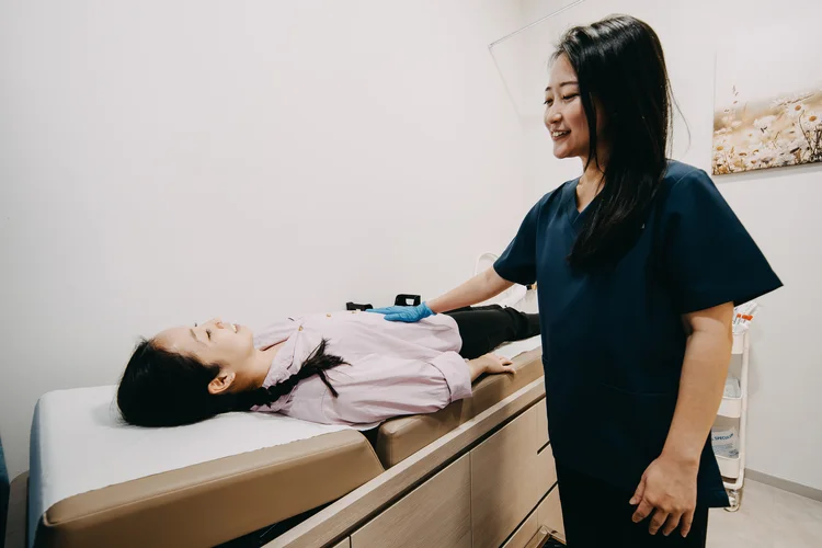 Dr Jana Lim doing a physical assessment on female patient during longevity health screening.