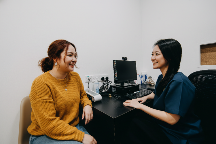 Doctor providing pre-travel consultation to female patient for South Africa.