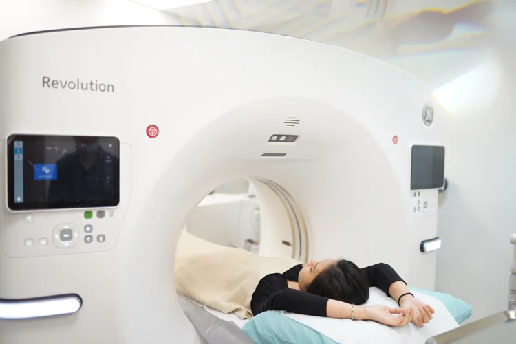 Female patient undergoing magnetic resonance elastography (MRE) to create detailed images of liver stiffness over a larger area, allowing for more precise detection of changes in the liver.