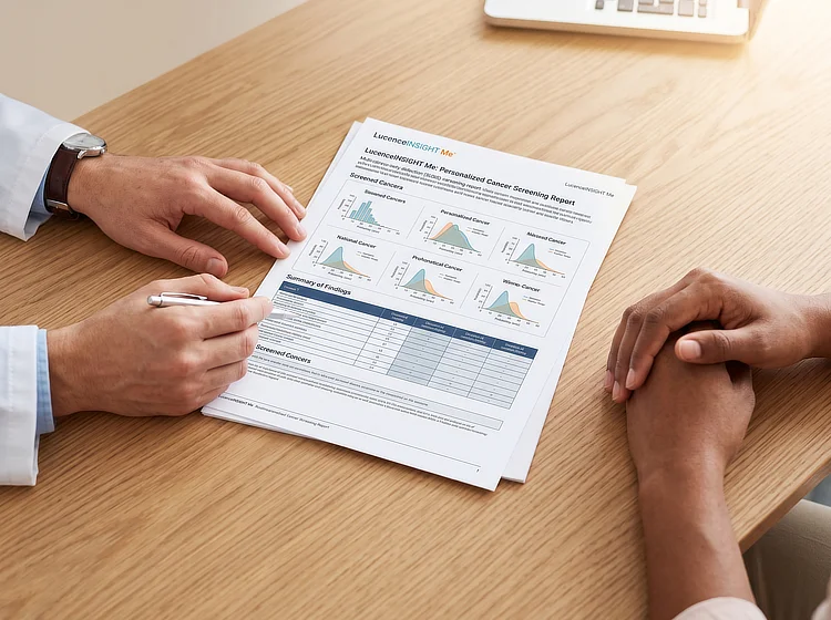 Doctor going through a LucenceINSIGHT Me cancer screening report with a patient.