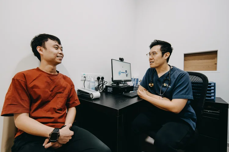 Male patient having a STD consult with male doctor.