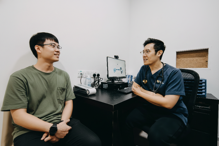 Male patient consulting doctor about travel vaccinations for South America trip.