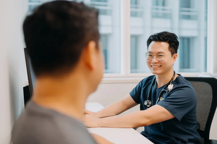 Dr Leonard Leng of ATA Medical having a consultation session with a male patient.