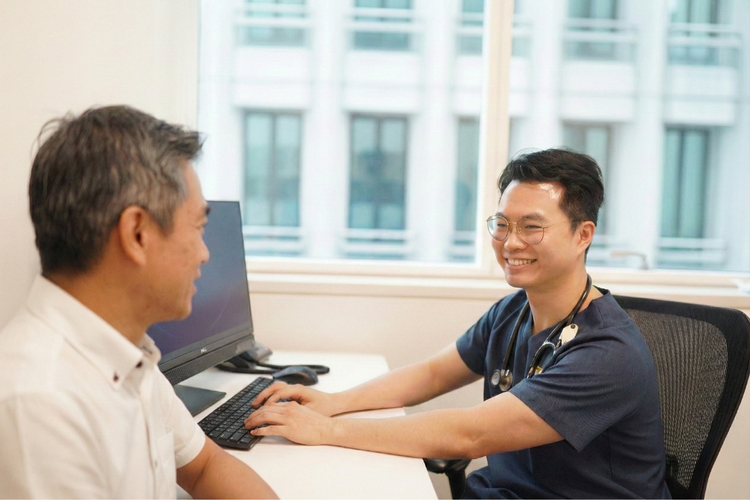 Senior man consulting male doctor during SPF aged driver medical check-up.