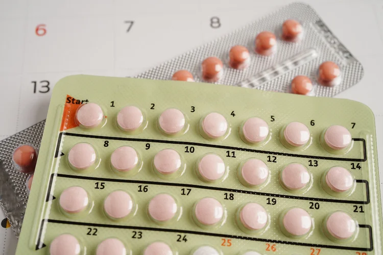 Oral contraceptive pill pack with daily dosing labels showing 21-day and 28-day pill regimens.