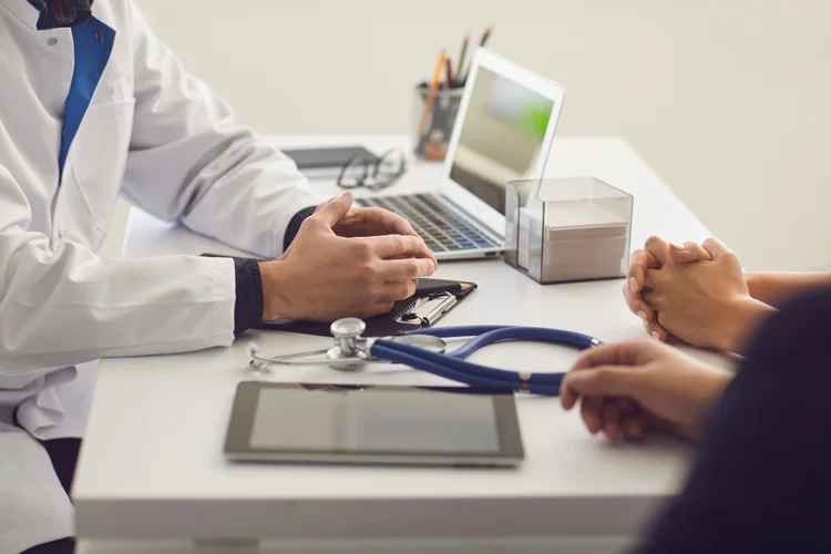 Patient consulting doctor about SPOT-MAS Cancer Blood Test during pre-screening discussion.