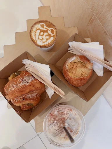 Cozy corner at Puzzle Coffee ION Orchard Singapore with edible coffee cups and pastries.