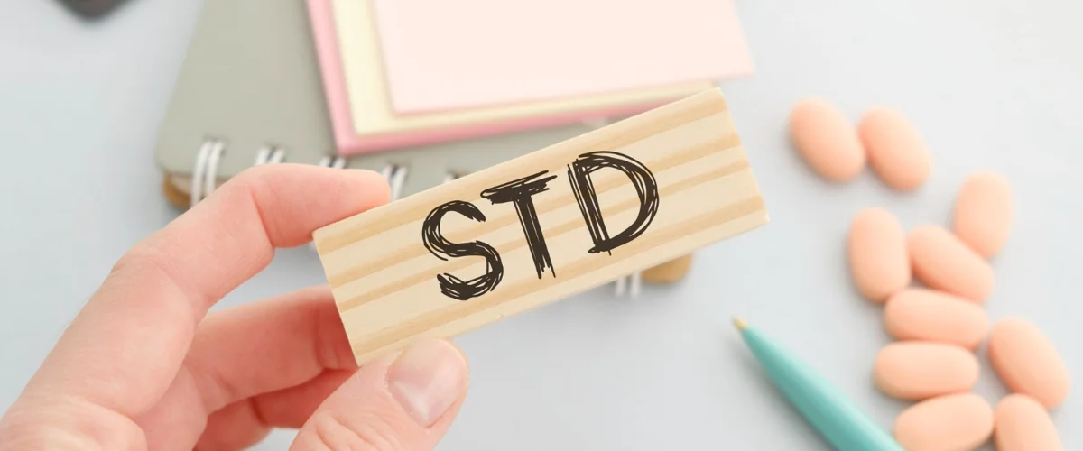 STD lettering on wooden block.